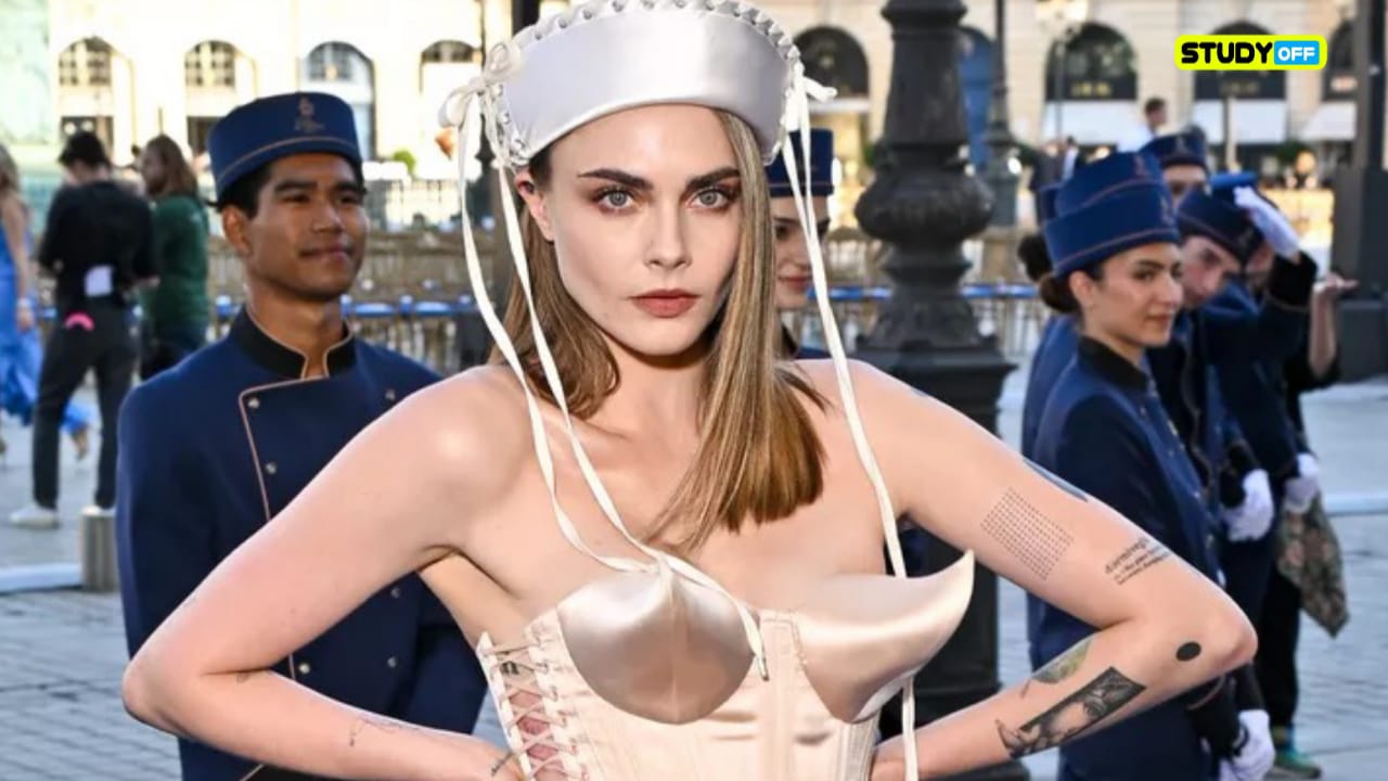 Just before hosting, Cara Delevingne sports a cone bra corset and a bow-adorned sailor hat, going all nautical. Vogue France